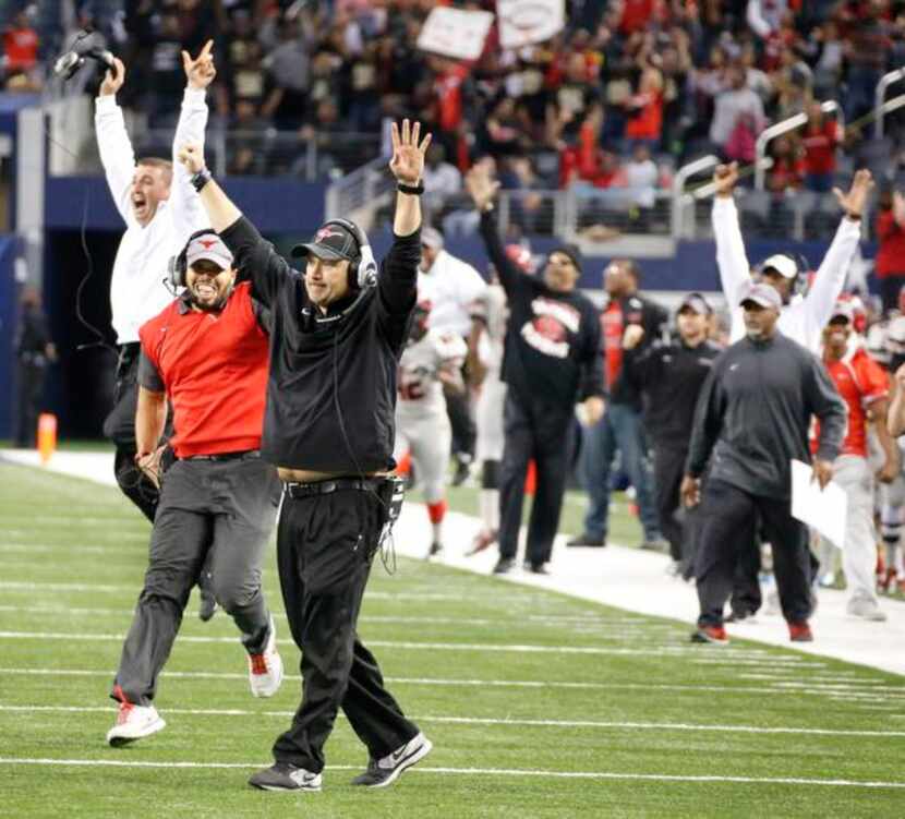 Cedar Hill head coach Joey McGuire and his staff celebrate as the Longhorns score the...