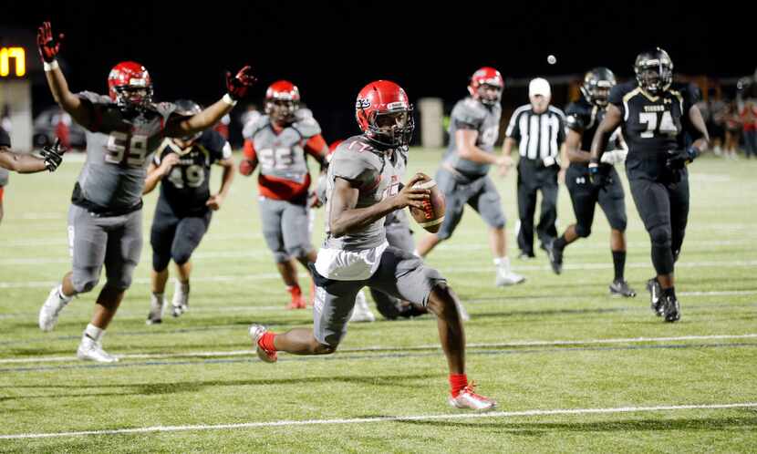 TXHSFB Cedar Hill junior quarterback Shayne Lawrence (17) scores a touchdown during the...