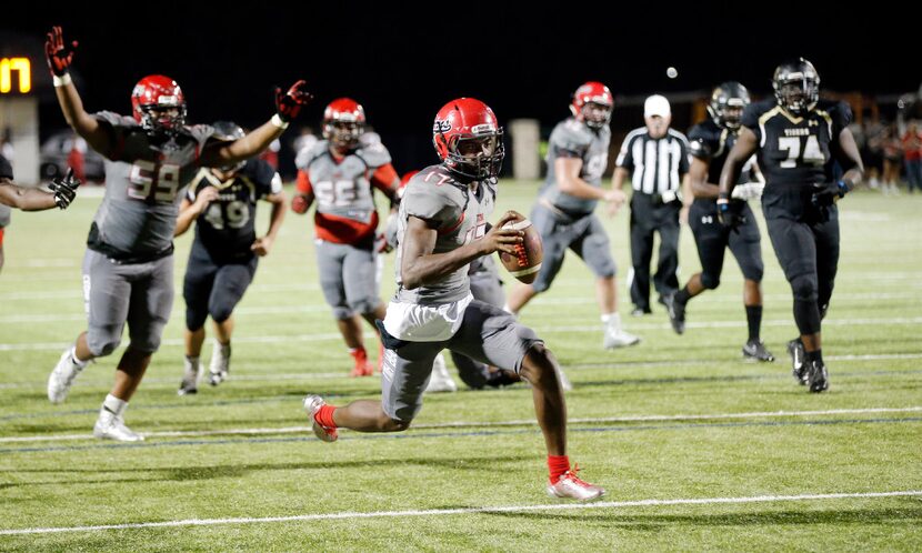 TXHSFB Cedar Hill junior quarterback Shayne Lawrence (17) scores a touchdown during the...