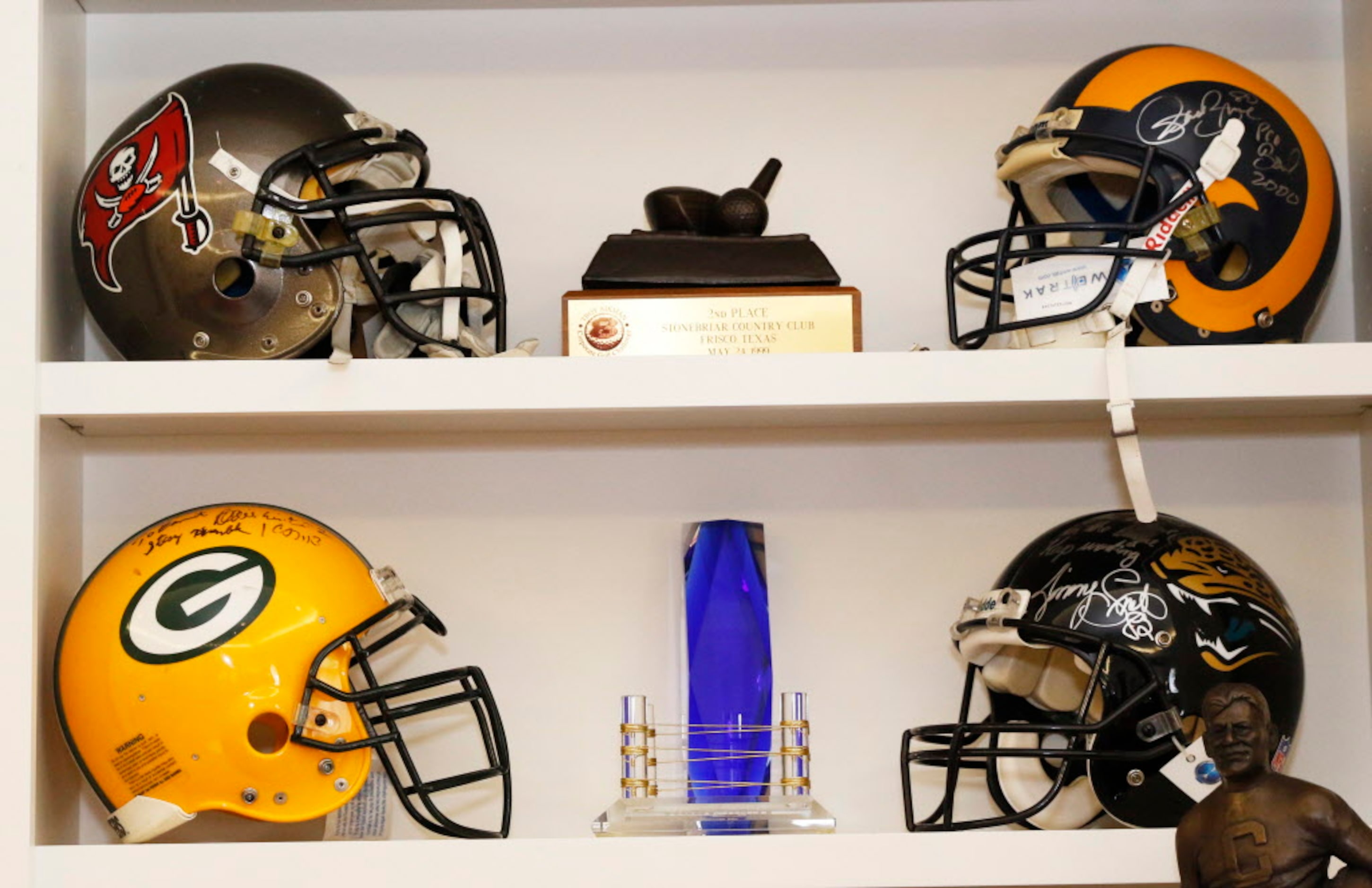 NFL helmets signed by friends of former Dallas Cowboys running back Emmitt Smith and other...