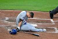 Texas Rangers' Corey Seager sits on the ground after being hit by a pitch thrown by...