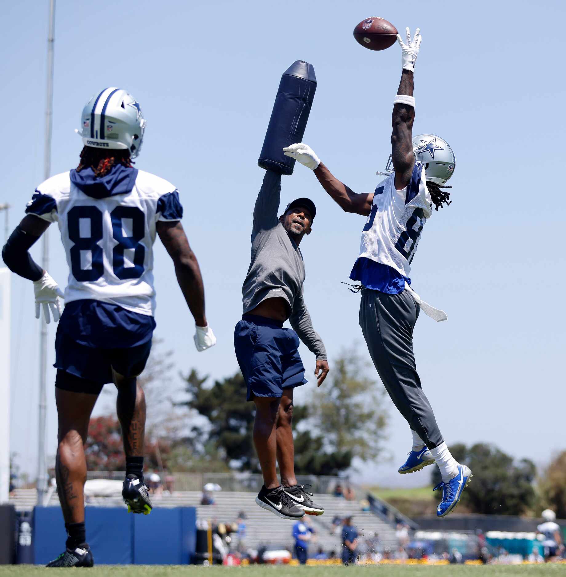 Dallas Cowboys wide receiver Noah Brown (85) goes high over wide receivers coach Robert...