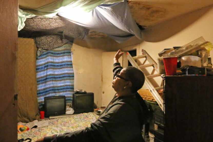  Joanne Bonner shows a ceiling with water damage in her home where she and her family live...