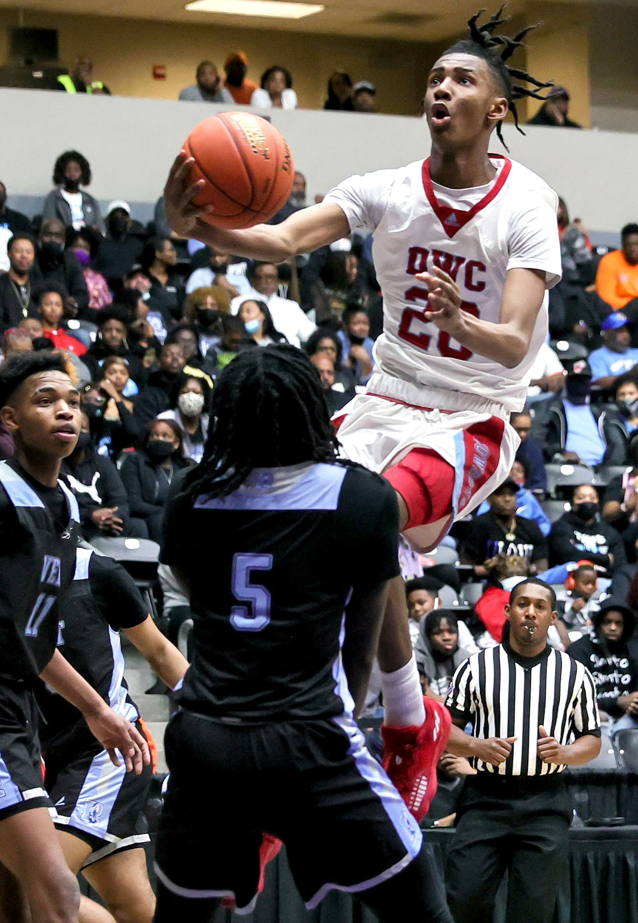 Carter forward Reece Bell (20) tries to go in for a layup against Roosevelt forward DaZion...