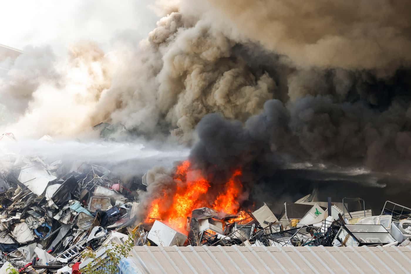 Fire and large plume of cloud appears from a pile of scrap metal at CMC Recycling, on...