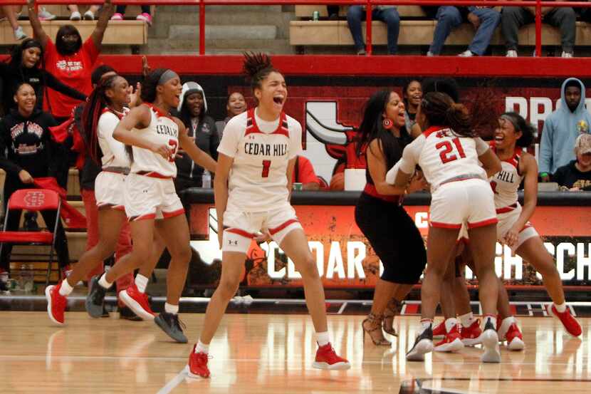 Cedar Hill head coach Nicole Collins celebrates with her players in front of the team bench...