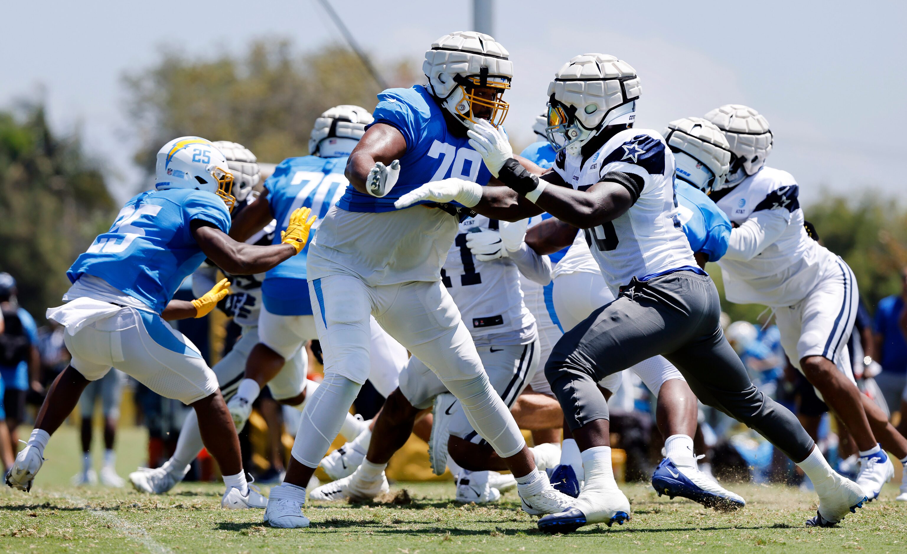 Dallas Cowboys defensive end DeMarcus Lawrence (90) pass rushes on Los Angeles Chargers...