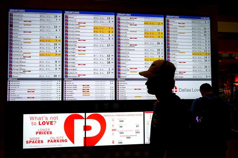 A flight status board at Dallas Love Field showed multiple Southwest Airlines cancellations...