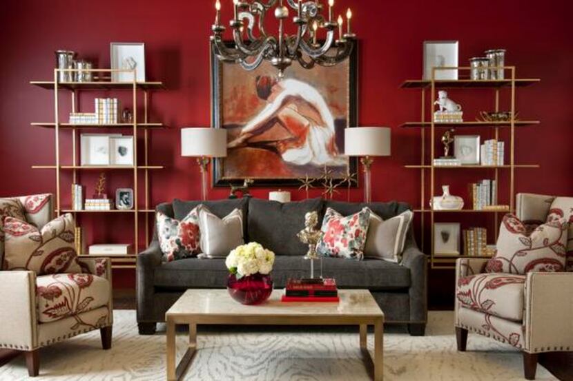 
A red wall forms the backdrop for a living room vignette that mixes traditional and...