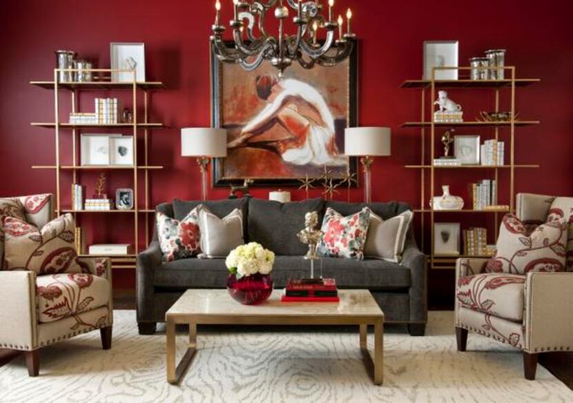 
A red wall forms the backdrop for a living room vignette that mixes traditional and...