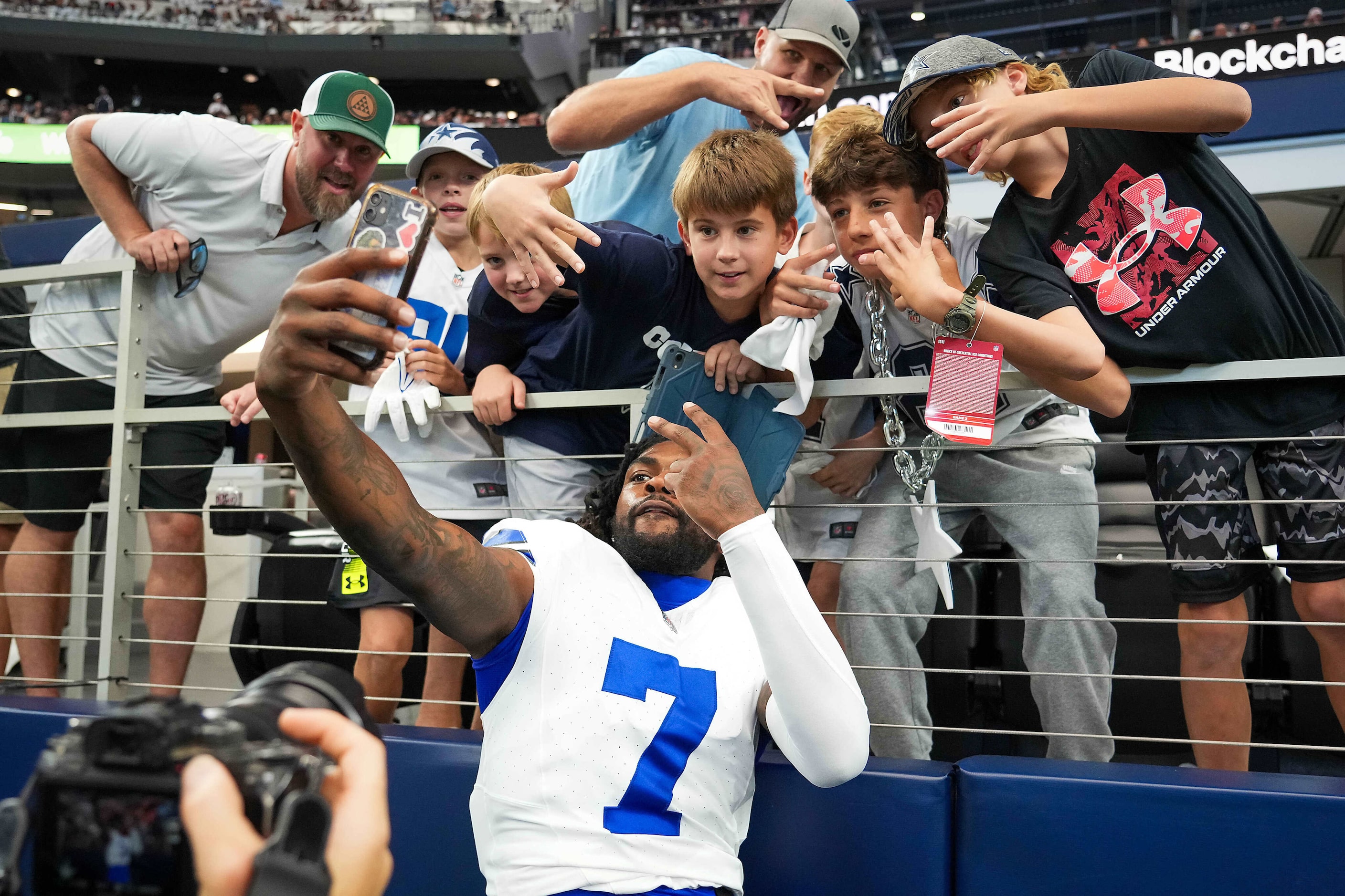 Dallas Cowboys cornerback Trevon Diggs (7) takes a selfie with fans before an NFL football...