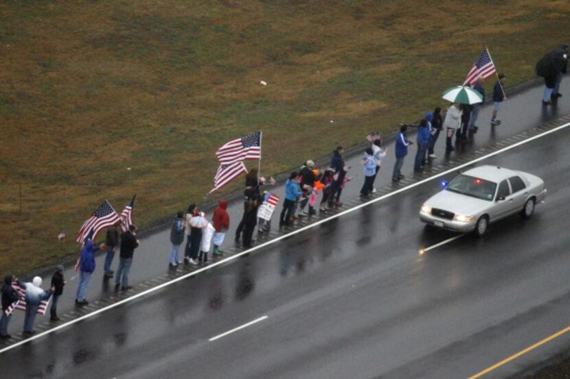 Hundreds of people turned out Tuesday in the rain along U.S. Highway 287 between Midlothian...