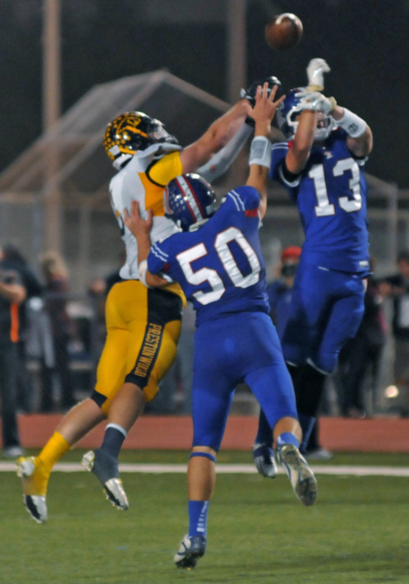 Trinity Christian Academy seniors Chad Baldwin (50) and Sam McQuilkin (13) break up a pass...