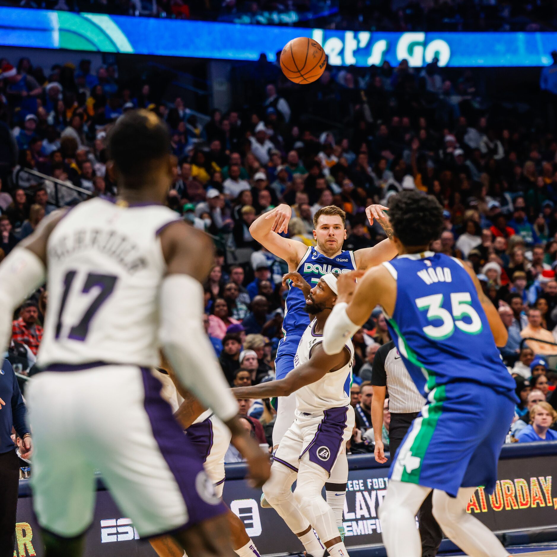 Dallas Mavericks guard Luka Doncic (77) makes a pass to forward Christian Wood (35) during...