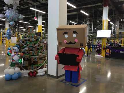 It's a tradition at Amazon fulfillment centers to have box men greeters during the holidays. 