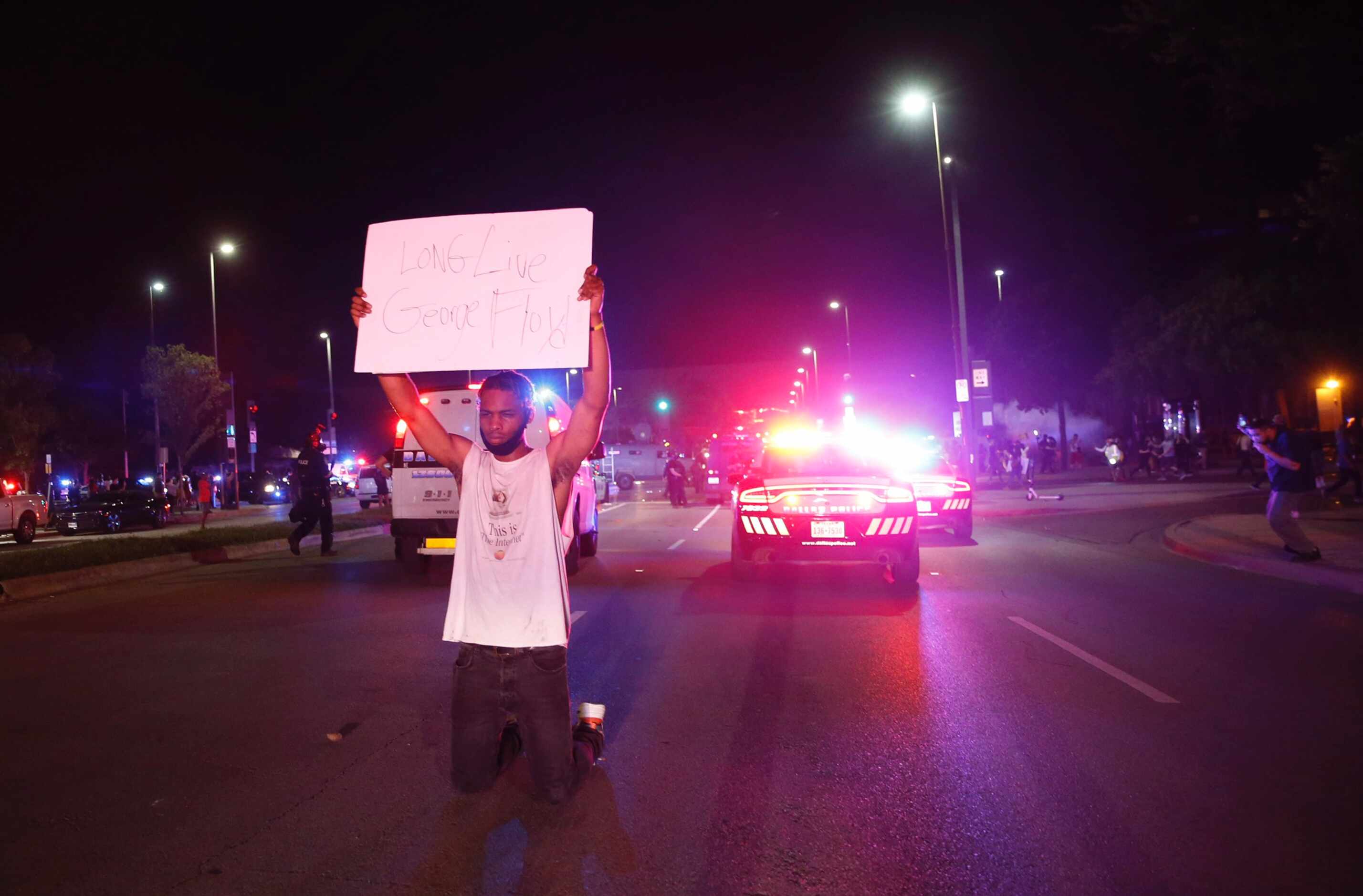 Jordan Spotser Of Dallas holds up a sign as protesters rally during a demonstration against...