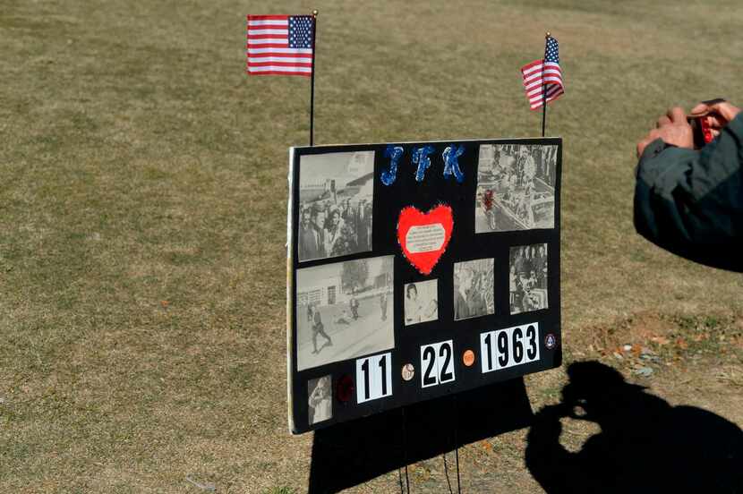 
Tourists photographed signs at Dealey Plaza on Sunday, 52 years to the day after President...