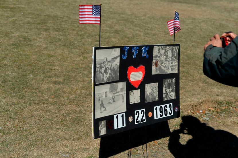 
Tourists photographed signs at Dealey Plaza on Sunday, 52 years to the day after President...