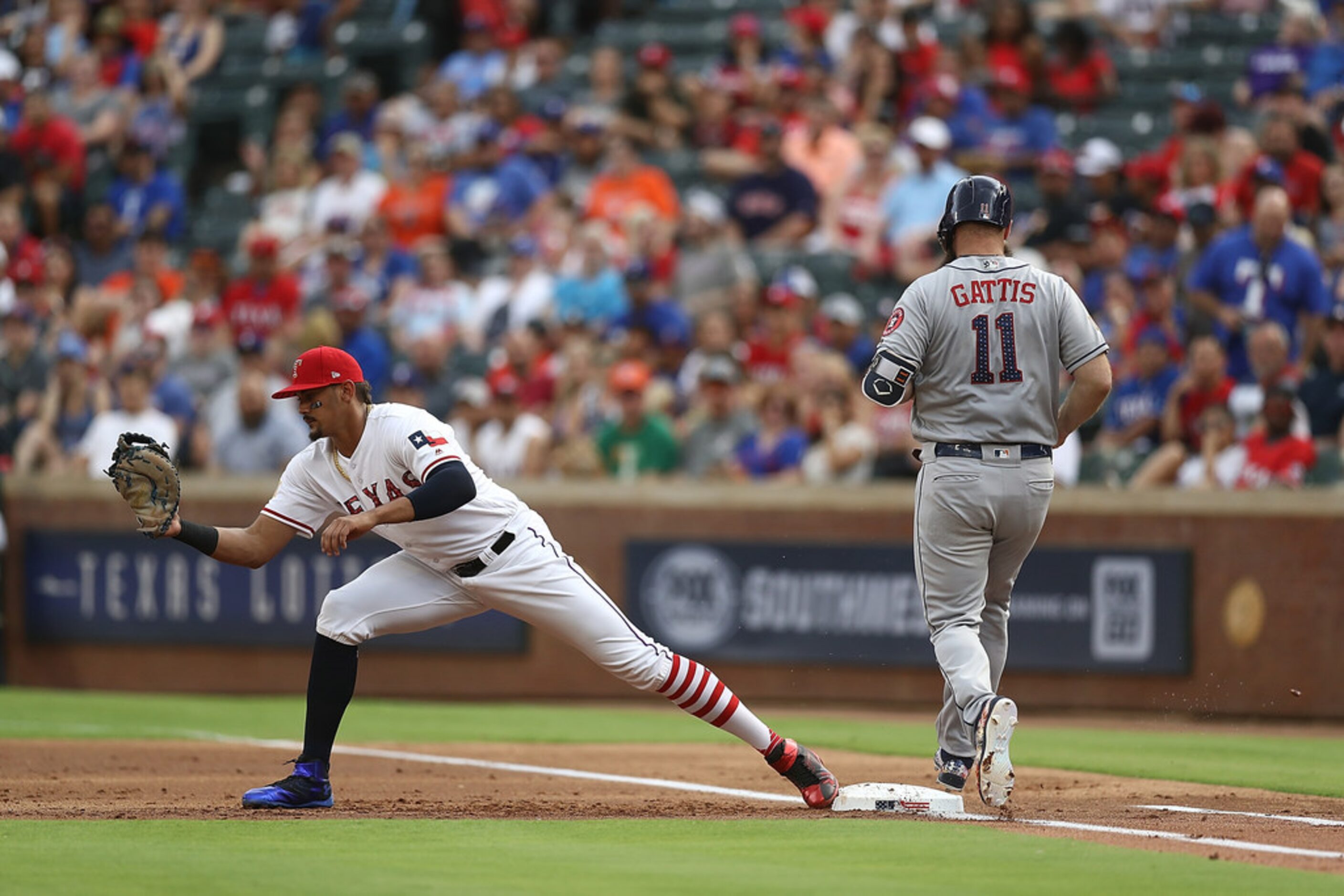 ARLINGTON, TX - JULY 04:  Ronald Guzman #67 of the Texas Rangers makes the out against Evan...