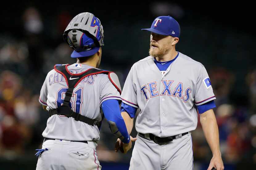 Texas Rangers pitcher Jake Diekman and Robinson Chirinos (61) celebrate after defeating the...