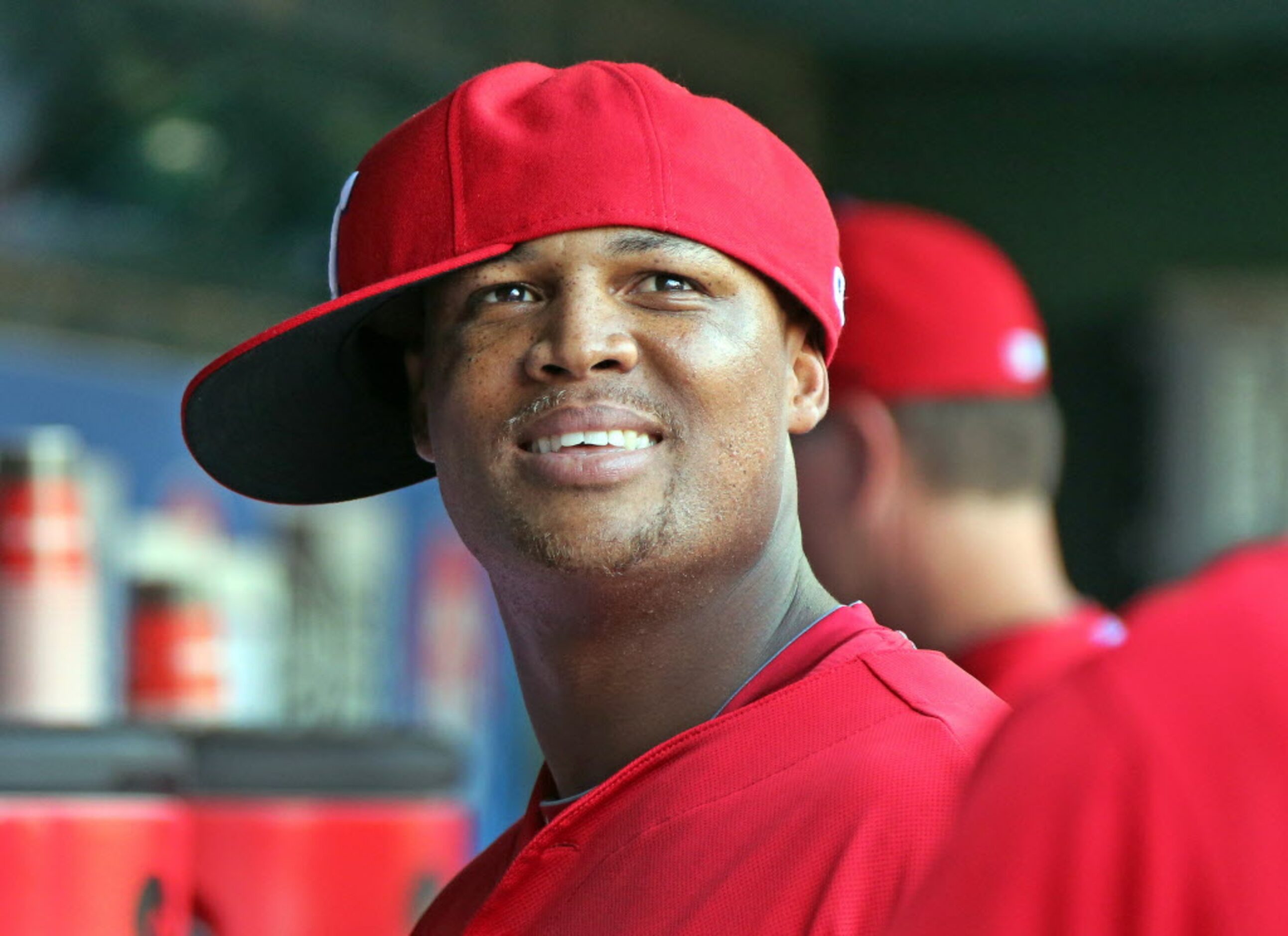 Texas third baseman Adrian Beltre clowns around in the dugout, wearing infielder Jeff...