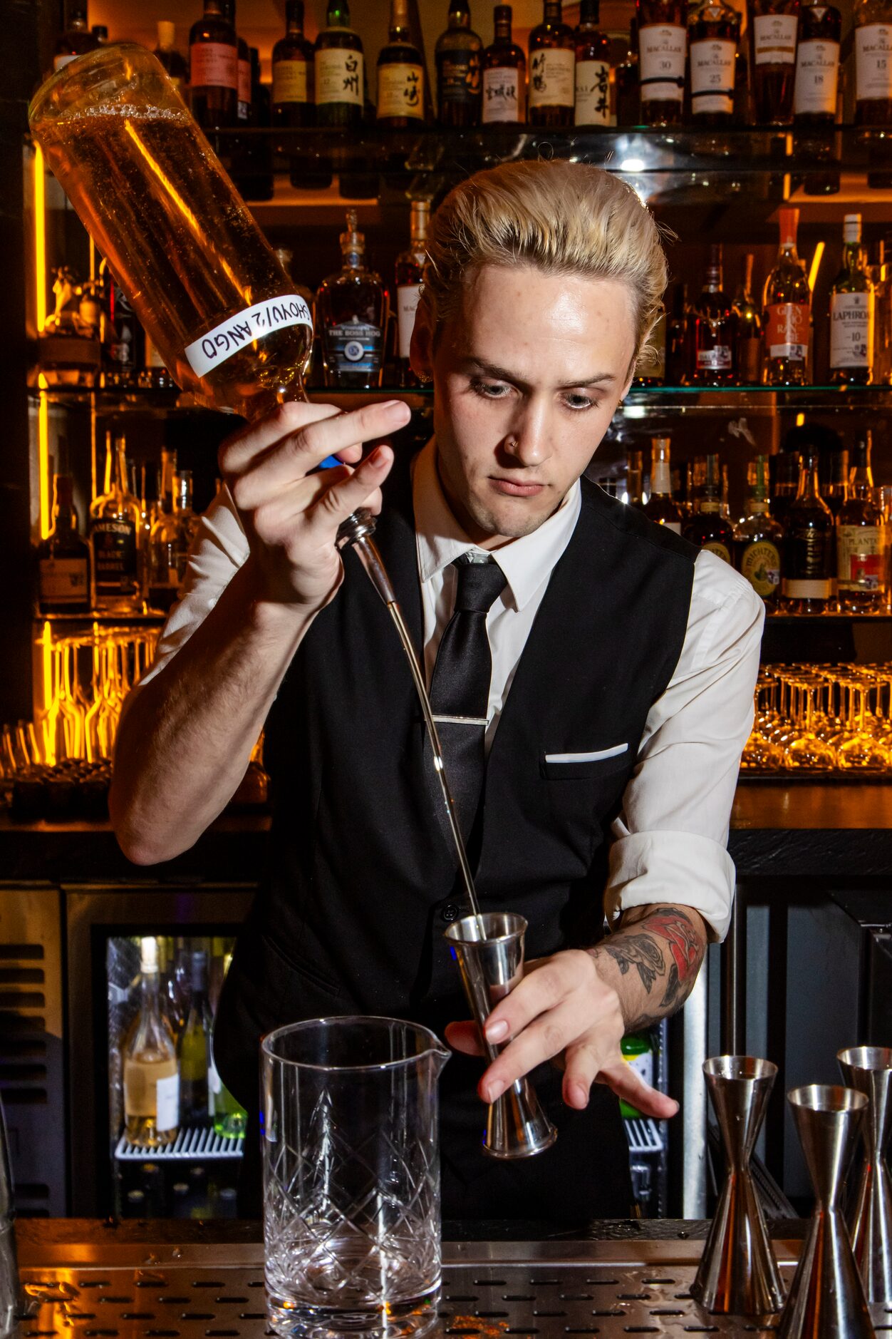 Bartender Jacob Claiborne prepares a Duck Old Fashioned, duck fat-washed Garrison Bros small...