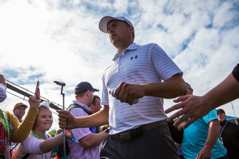 Jordan Spieth high-fives fans as he makes his way to the first tee during round 3 of the...