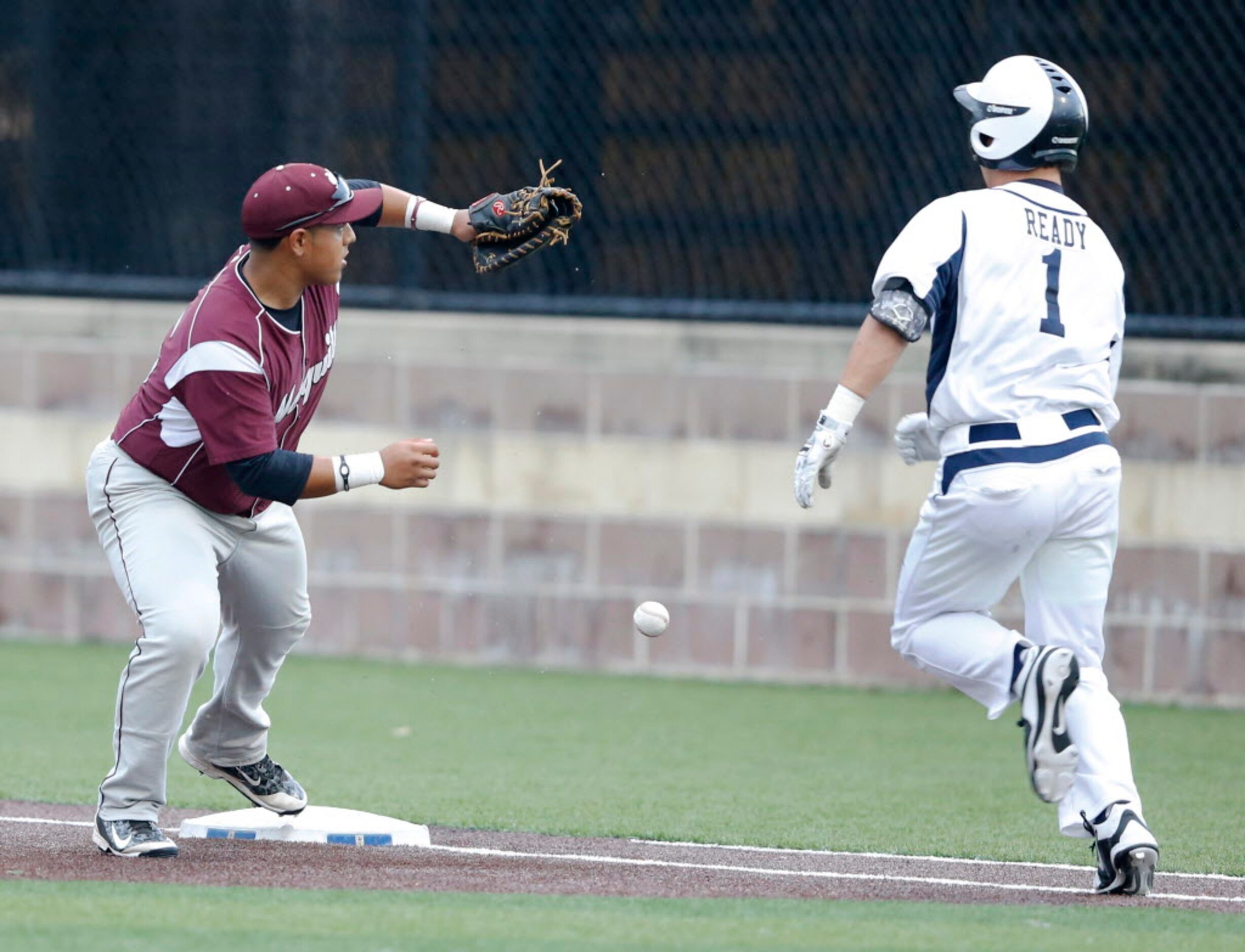 Mesquite's Mannie Martinez mishandles the ball as Jesuit's Mark Ready (1) safely runs to...