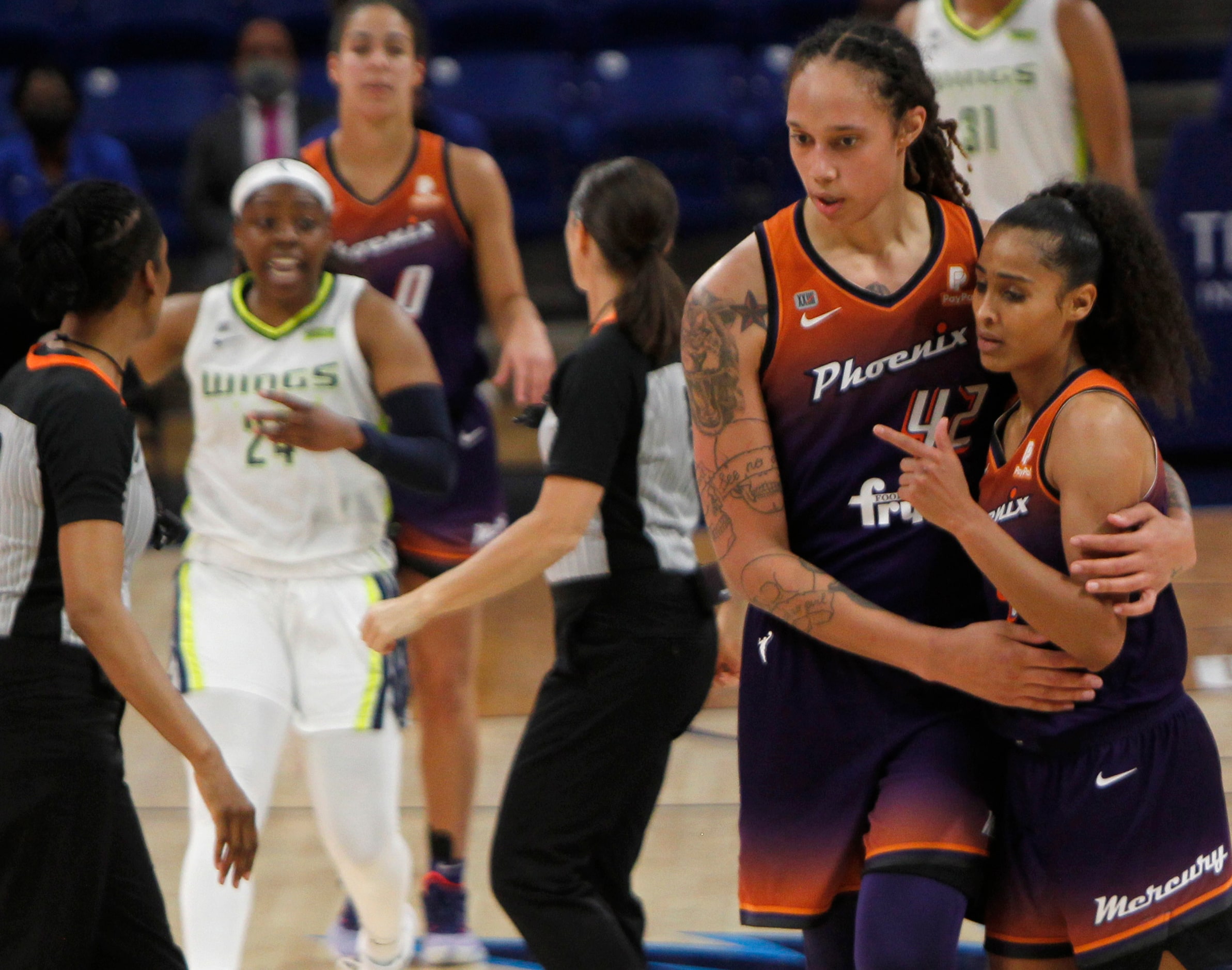 Phoenix forward Britney Griner (42) steps in to intervene and help guide teammate Skylar...