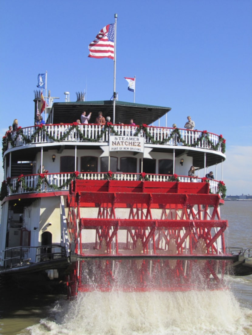 Bedecked with garlands and big red bows, the Steamboat Natchez takes Christmas Eve diners...