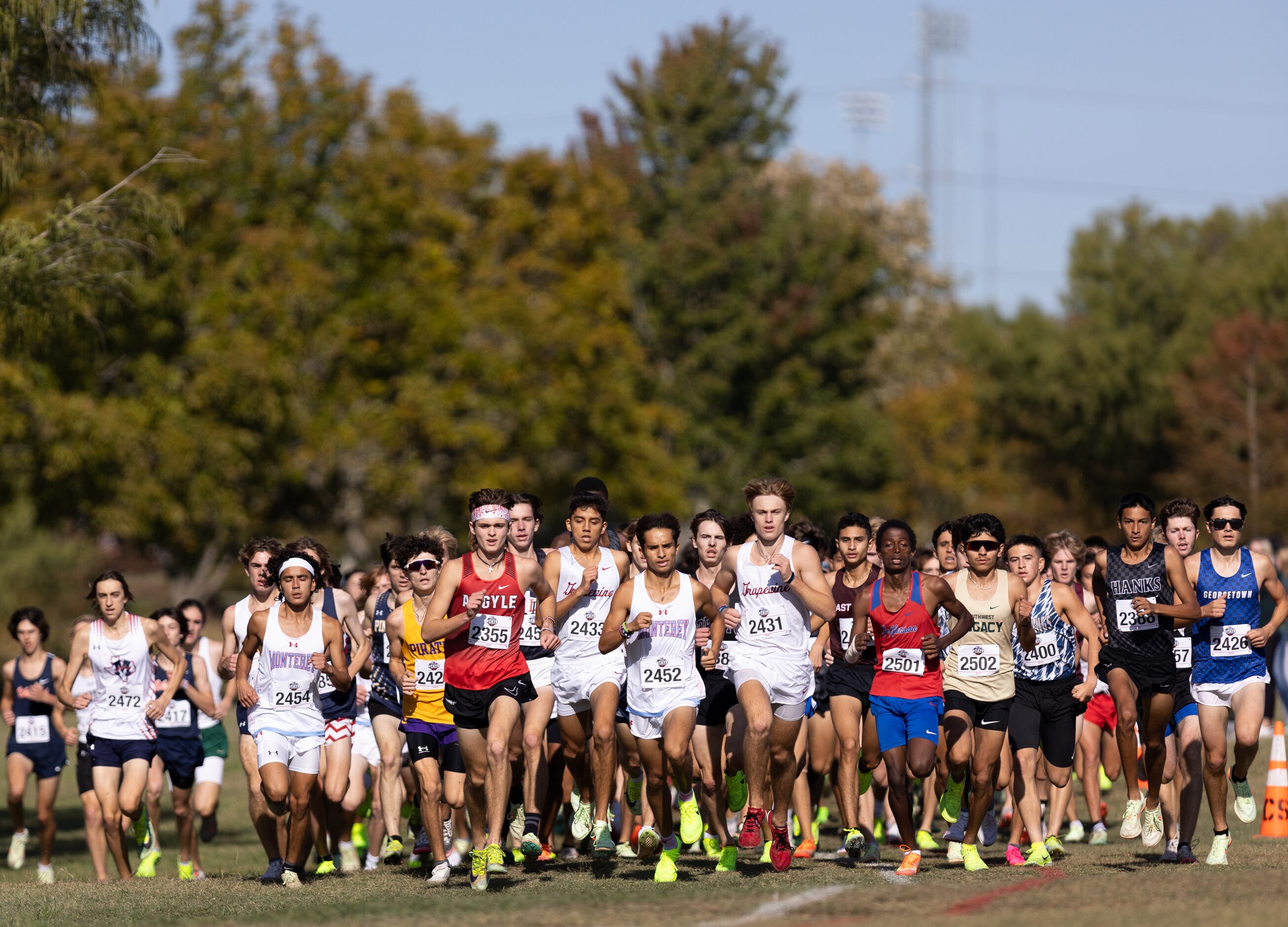 Alberto Rayon and Adam Burlison of the Grapevine Mustangs run among the leaders of the 5A...