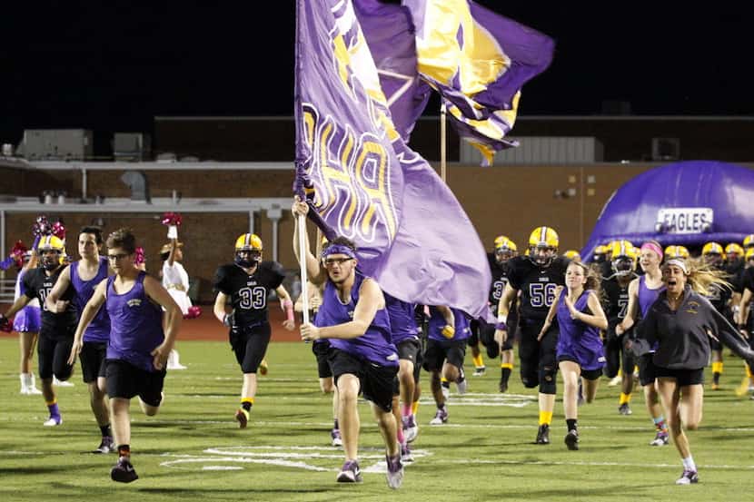 The Richardson football team and supporters take the field before the start of a high school...