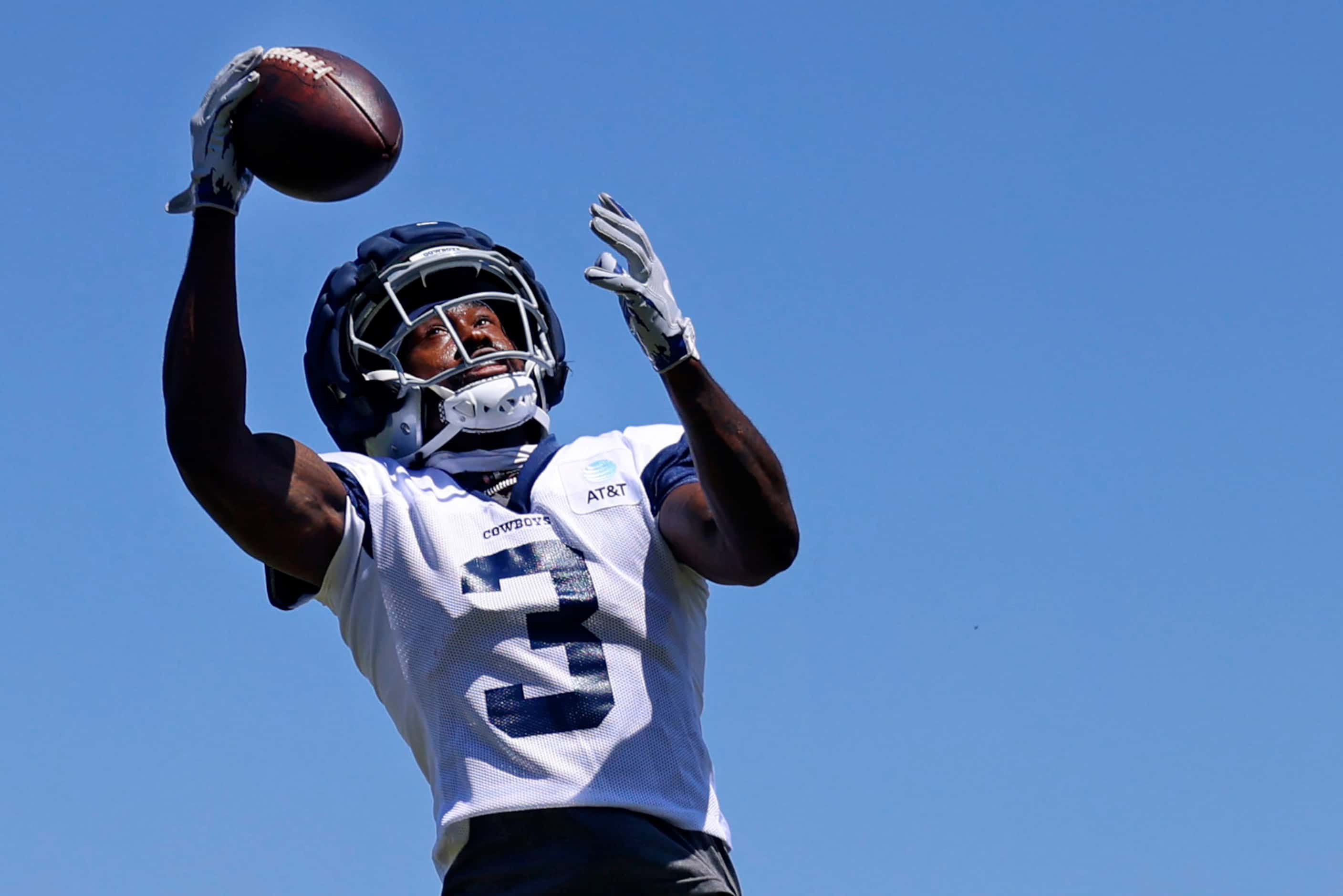 Dallas Cowboys wide receiver Brandin Cooks (3) reaches for a high pass during training camp...