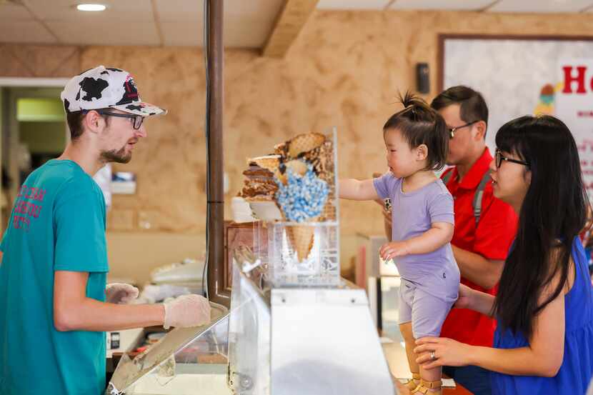 William Laidlaw (left) takes an ice cream order from Evangeline Kang, 18 months, Victor Kang...