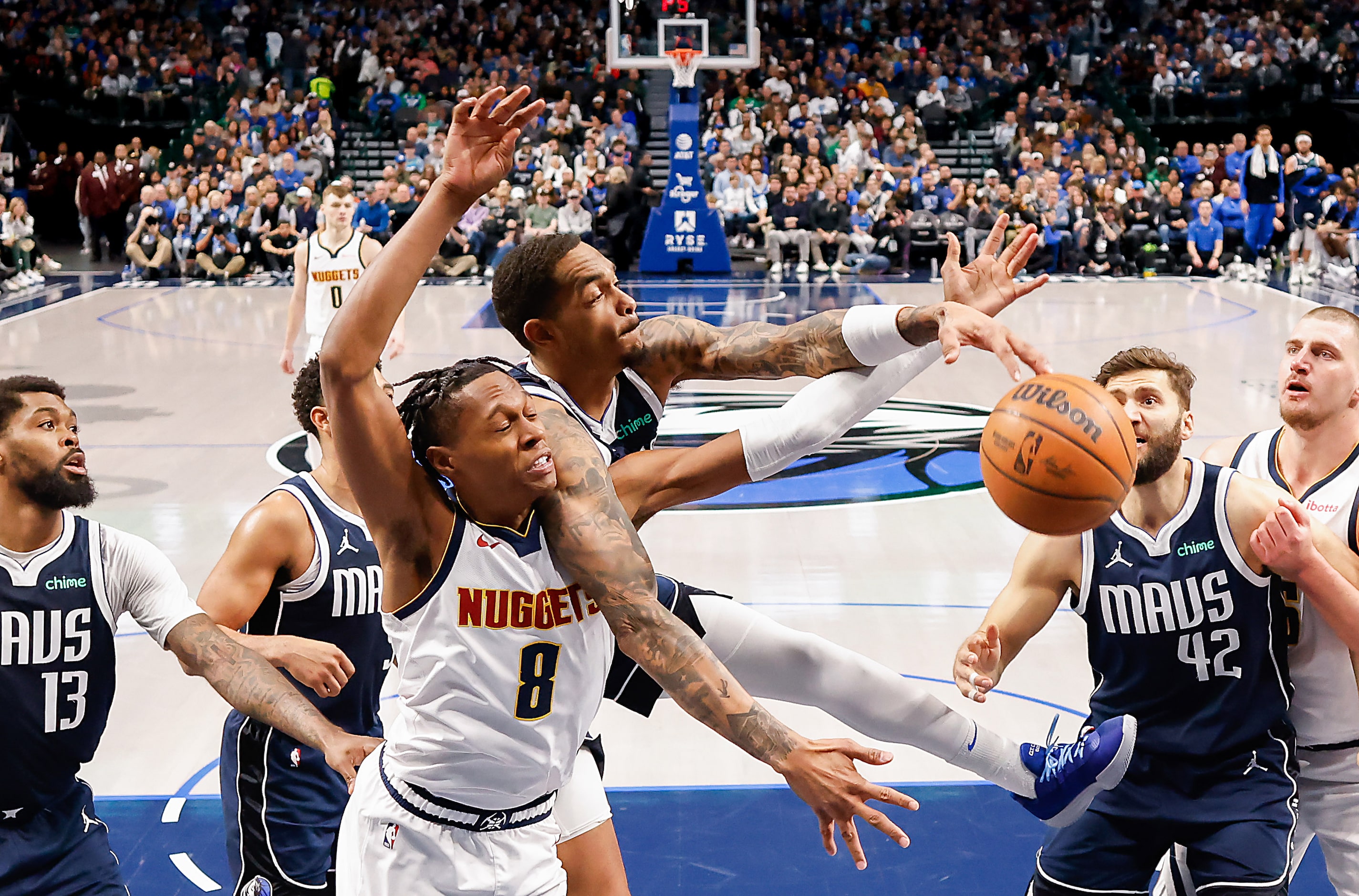 Dallas Mavericks forward P.J. Washington (25) fights for an offensive rebound against Denver...