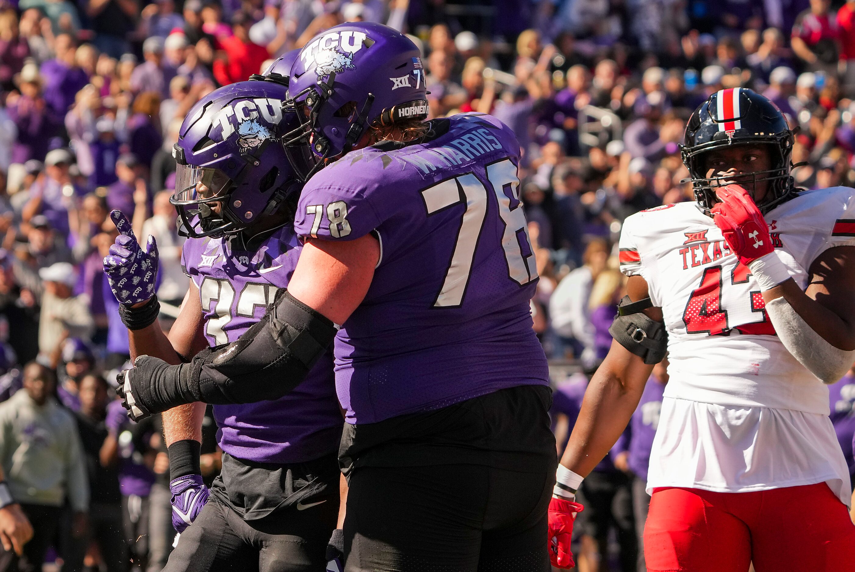 TCU running back Kendre Miller (33) celebrates with guard Wes Harris (78) after scoring on a...