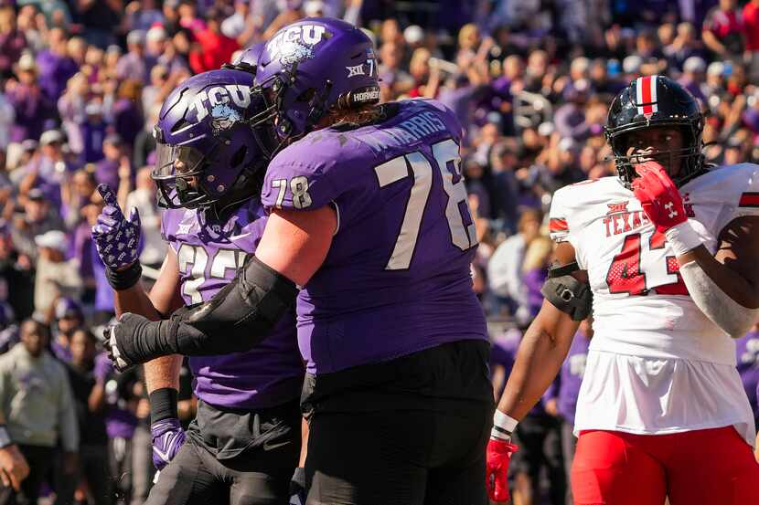 TCU running back Kendre Miller (33) celebrates with guard Wes Harris (78) after scoring on a...