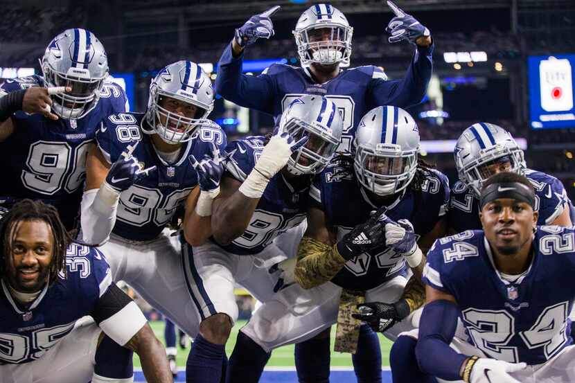 Dallas Cowboys players pose for a photo in the end zone after middle linebacker Jaylon Smith...