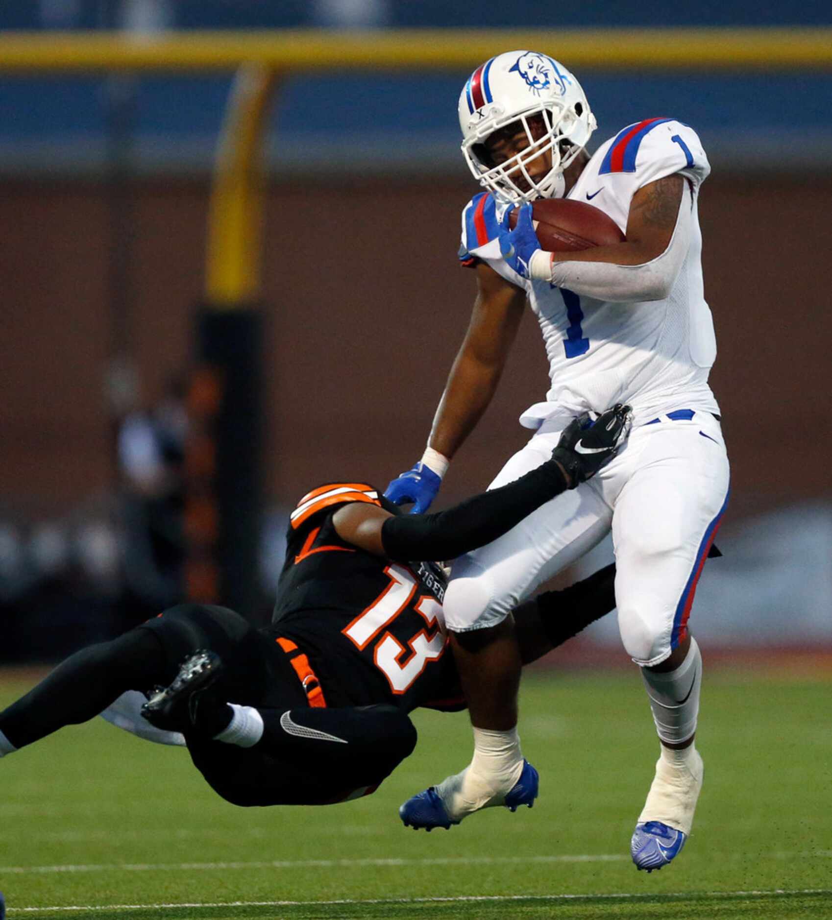 Duncanville running back Trysten Smith (1) is tackled by Lancaster defensive back Theron...