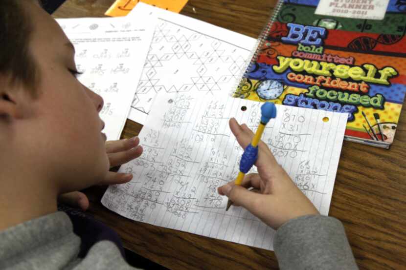 An Allen student does math calculations in this file photo. Beginning July 1, Allen ISD...