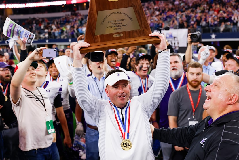 Anna high head coach Seth Parr lifts the trophy following their victory against Tyler Chapel...