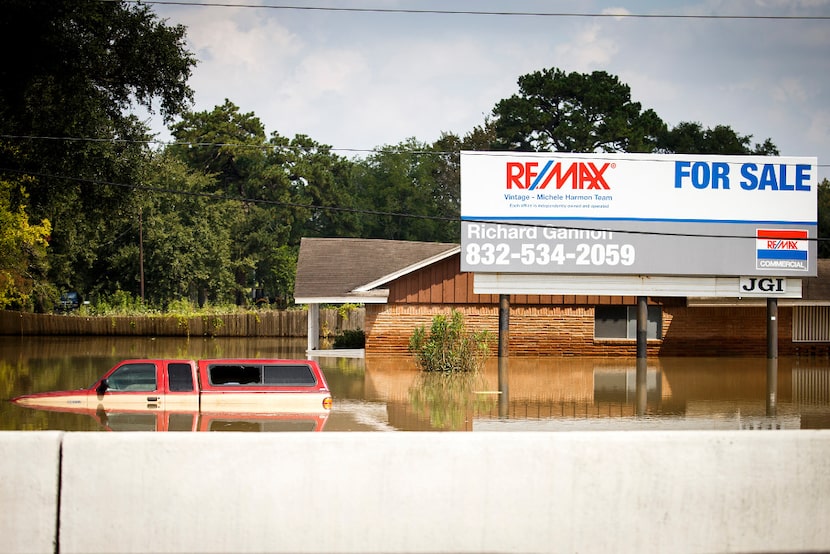 Floodwater from Hurricane Harvey remained around a house on the service road of Interstate...