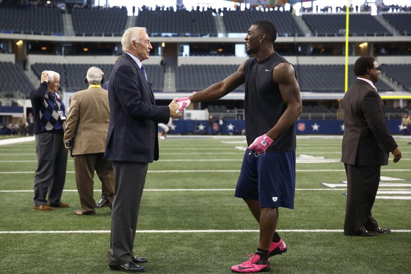 Dallas Cowboys owner Jerry Jones, left , and wide receiver Dez Bryant shake hands on the...