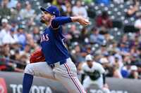 Texas Rangers starting pitcher Andrew Heaney throws in the first inning of a baseball game...