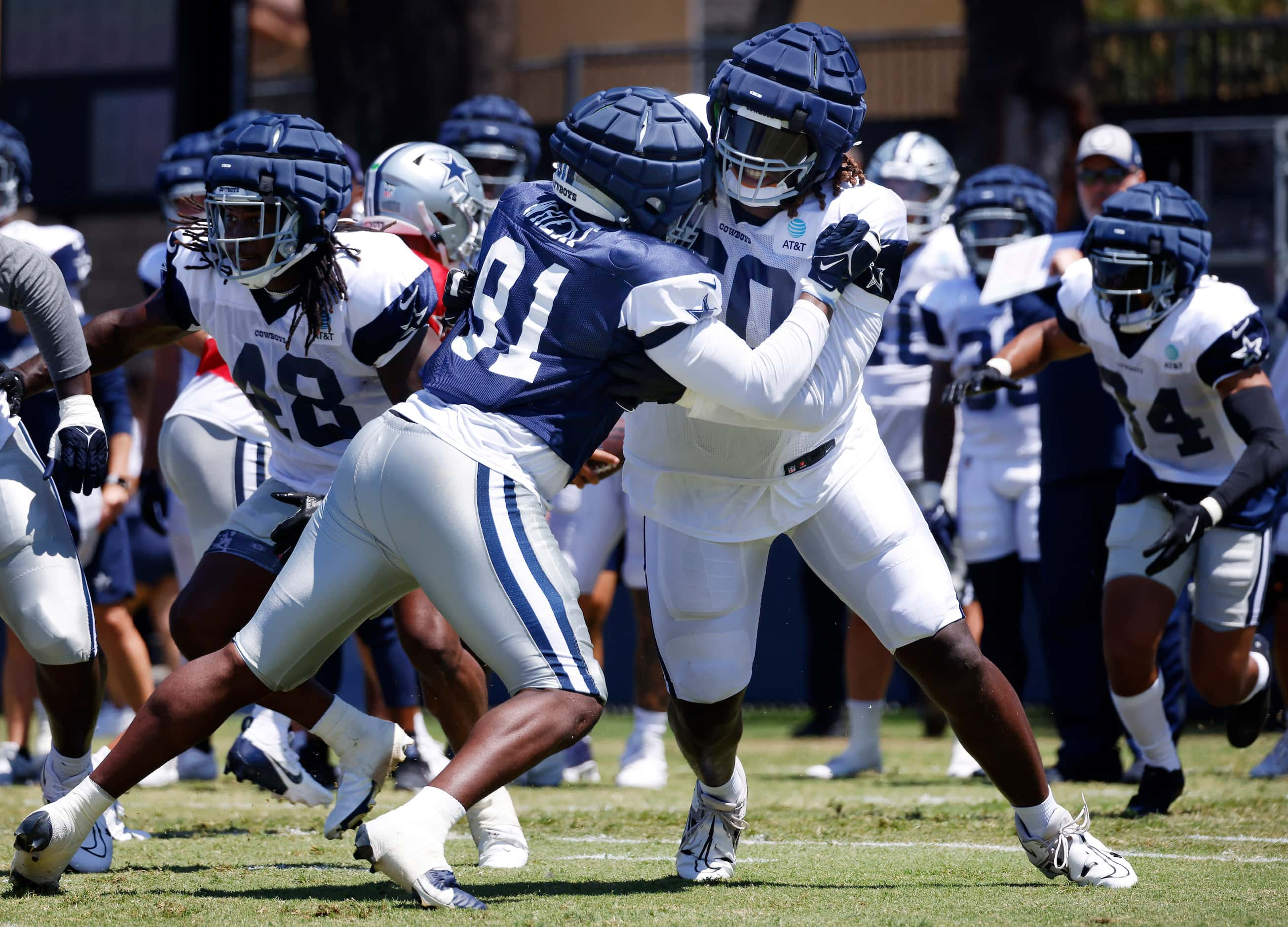 Dallas Cowboys tackle Tyler Guyton (60)  blocks defensive end Tyrus Wheat (91) during a...