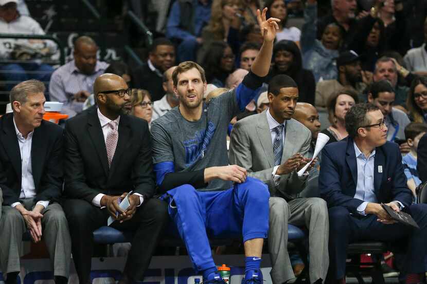 Dallas Mavericks forward Dirk Nowitzki (41) waves from the bench during the first half of a...