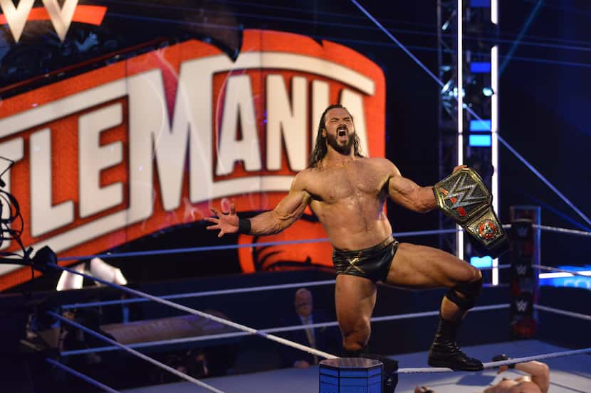 Drew McIntyre celebrates winning the WWE championship after defeating Brock Lesnar at...