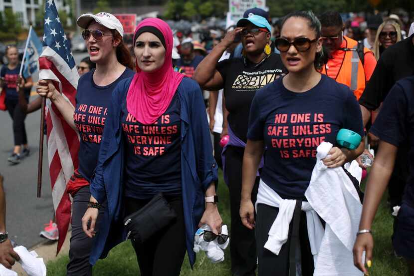 Linda Sarsour (center) and fellow gun-control activists participated in a march beginning at...