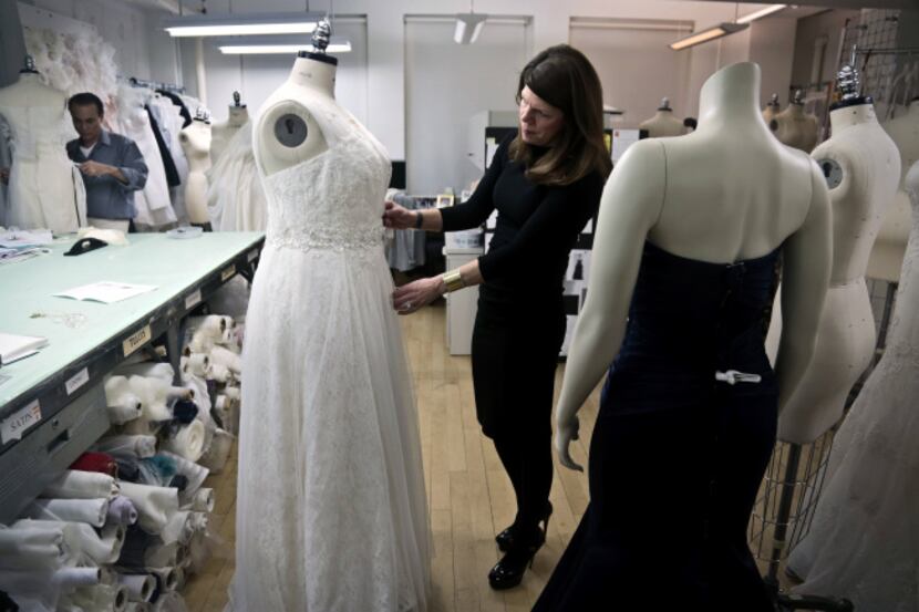 David’s Bridal senior vice president Michele von Plato arranges a dress on a plus-size...