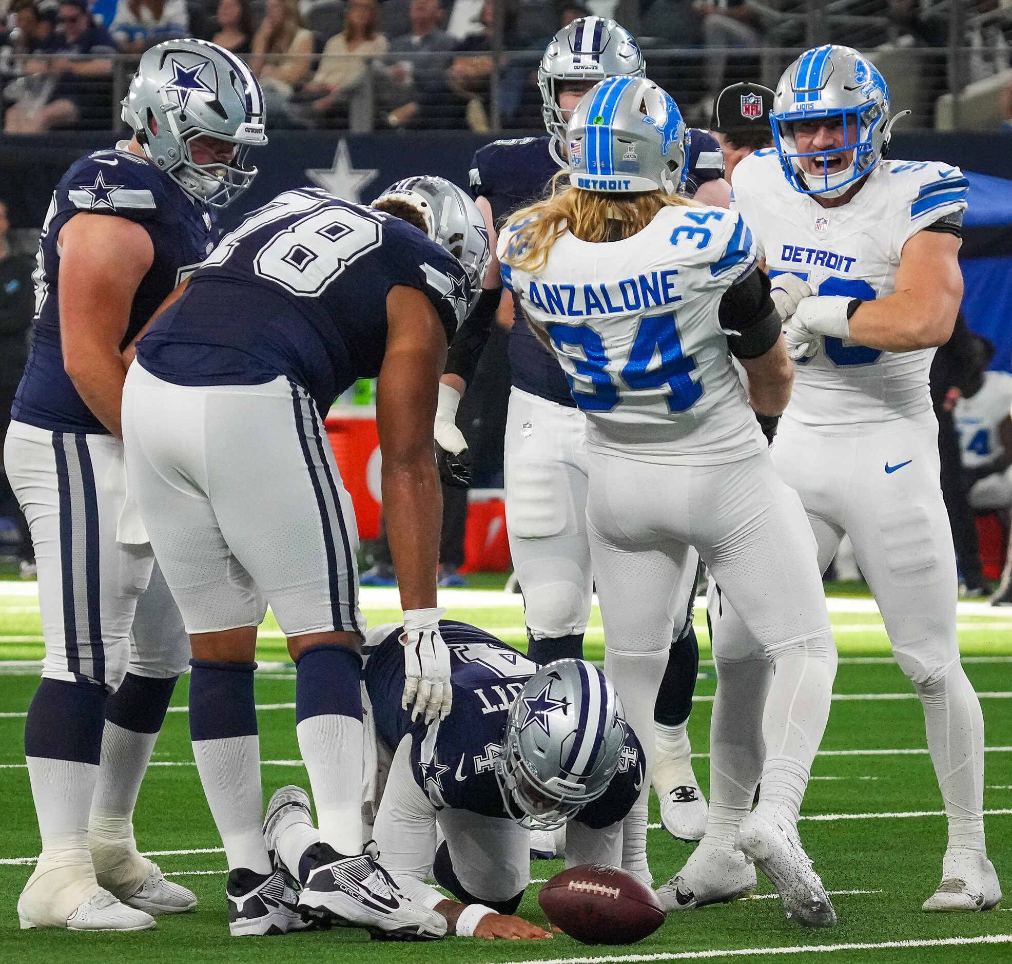 Dallas Cowboys quarterback Dak Prescott (4) is slow to get up as Detroit Lions linebacker...